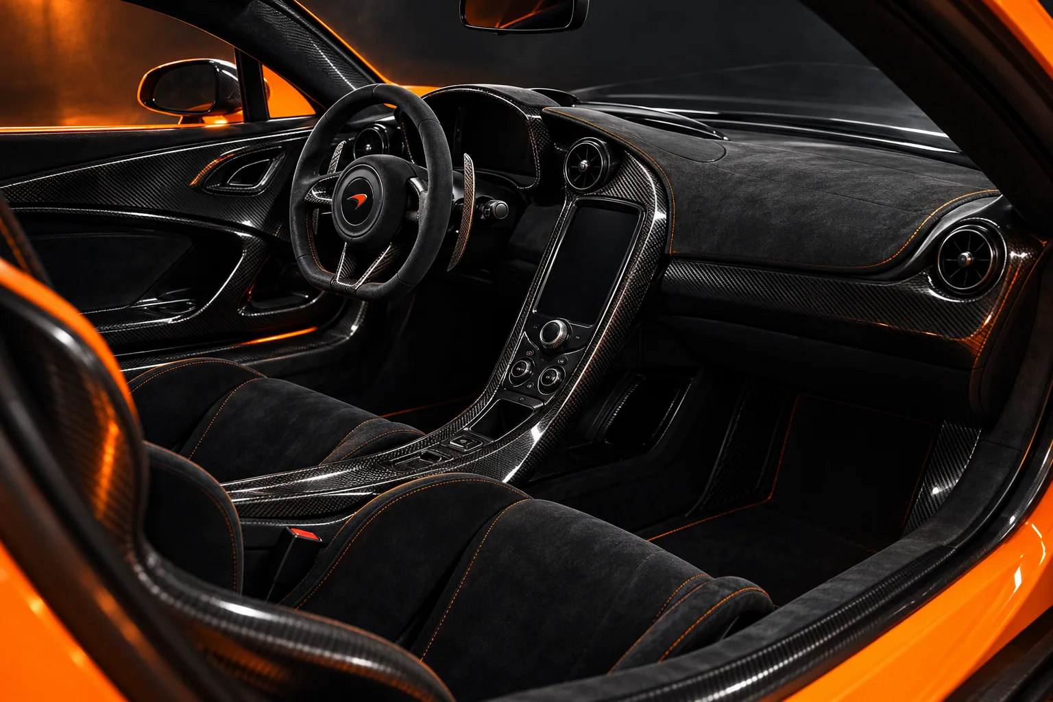 The P1’s dark carbon-fibre cockpit, Alcantara steering wheel and narrow central console.