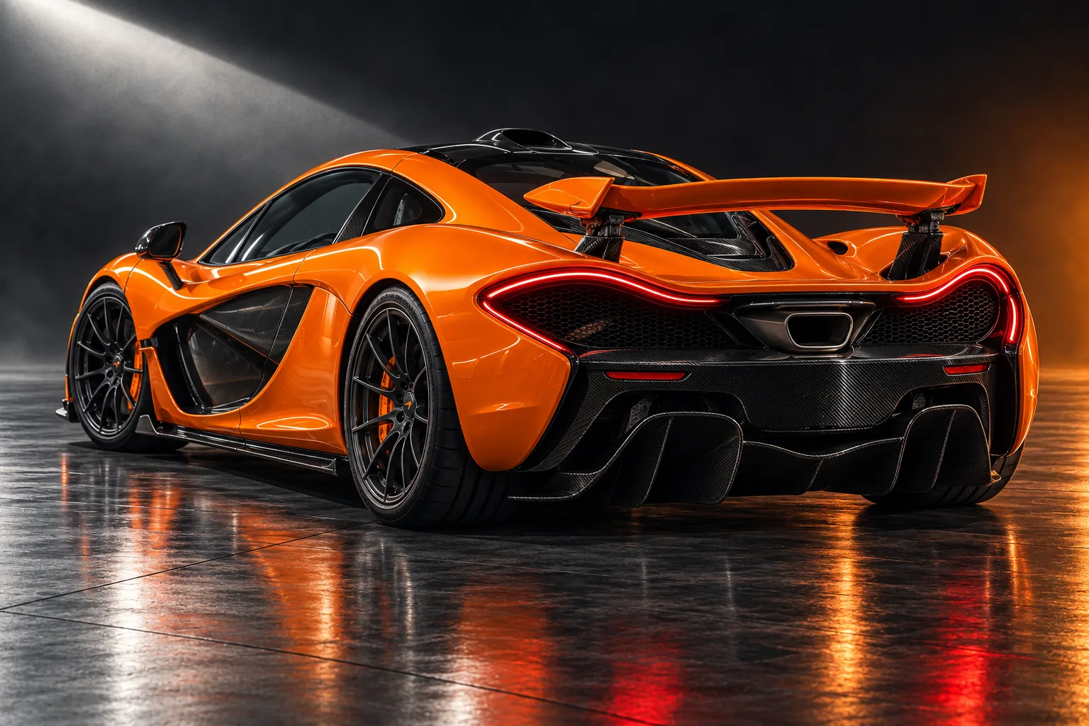 Rear three-quarter view of the orange P1, showing its sculpted wing, thin red tail lights and carbon diffuser.